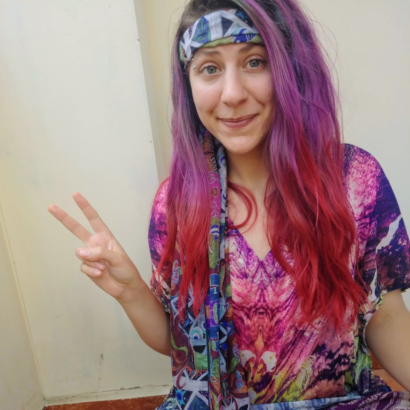 A photo of the writer giving the peace sign with hippie clothing