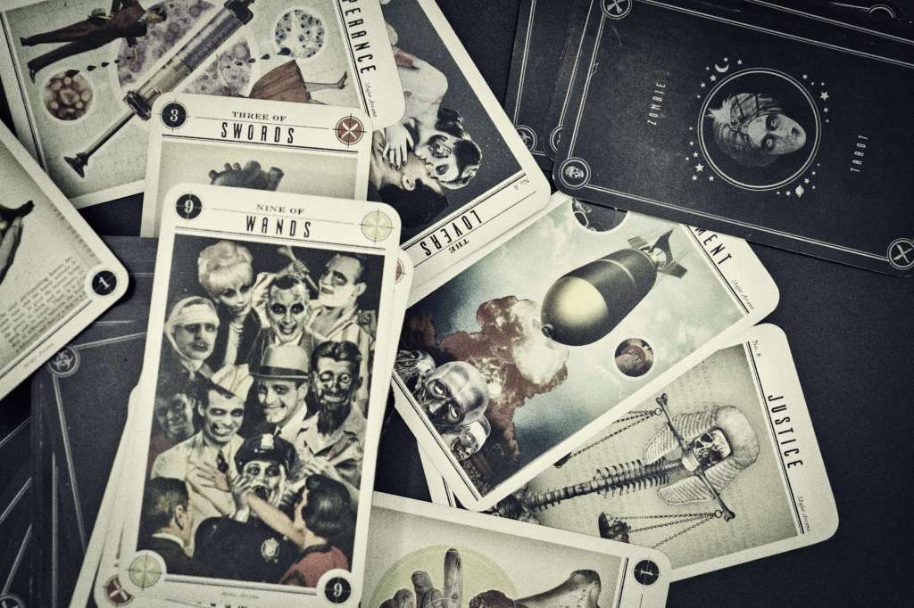 An image of an artistic style tarot deck with cards spread across a table